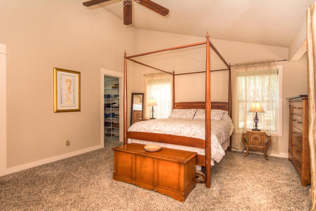 17065 Azusa Road Bend, OR 97707 - Photo 14 of 37 The Primary Suite also has vaulted ceilings, ceiling fan, a large walk-in closet and a large bath with double vanity, shower and a soaking tub.