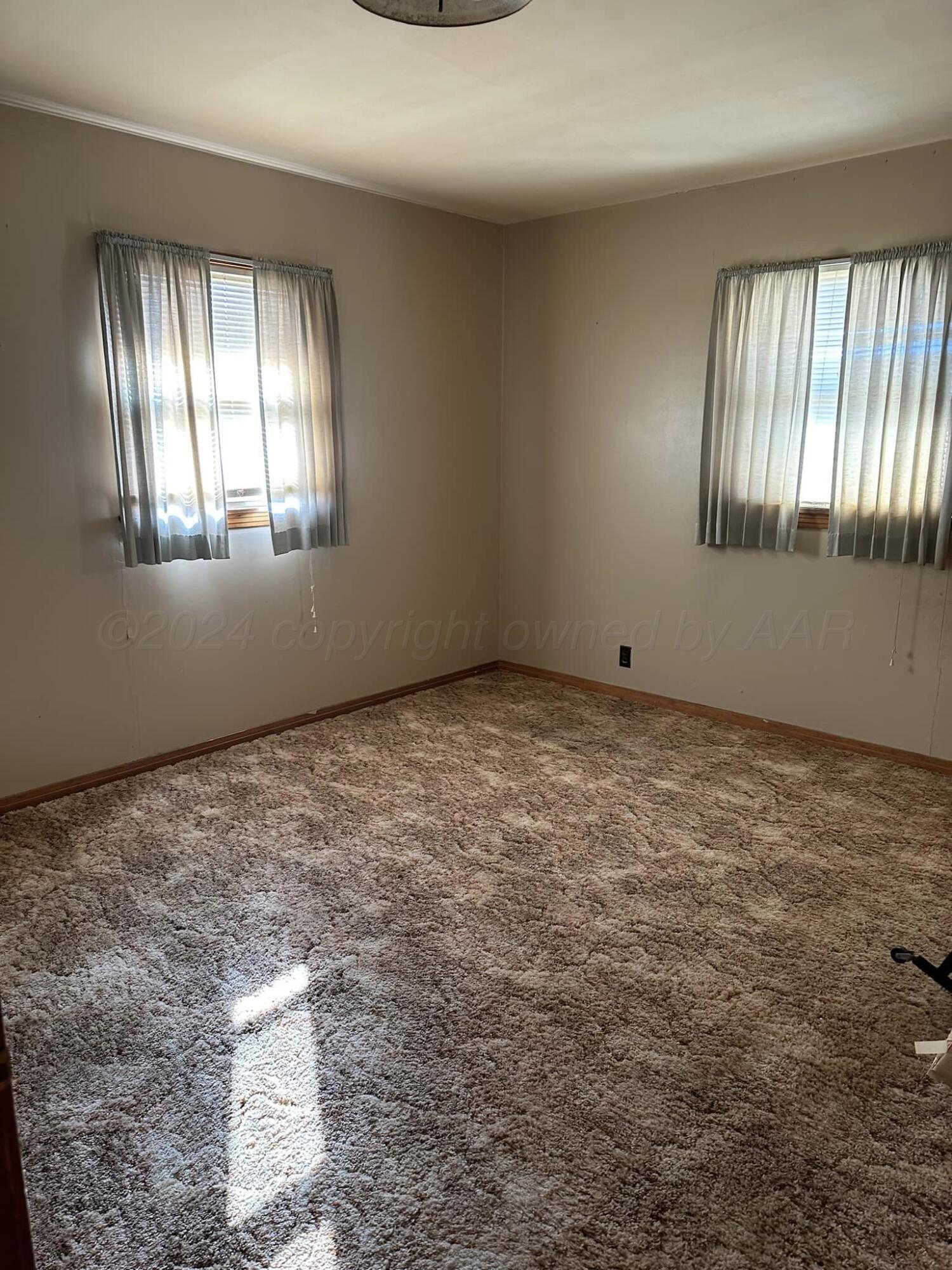 506 Ave O Sunray, TX 79086 - Photo 11 of 18 a view of an empty room with a window