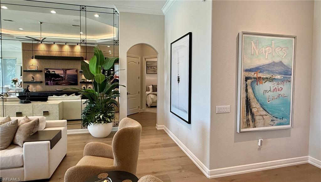 15536 Monterosso Lane, Unit 201 Naples, FL 34110 - Photo 11 of 29 a living room with furniture and a potted plant