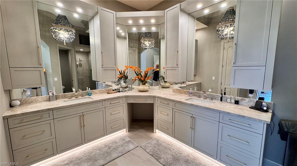 15536 Monterosso Lane, Unit 201 Naples, FL 34110 - Photo 14 of 29 a bathroom with a sink vanity and mirror