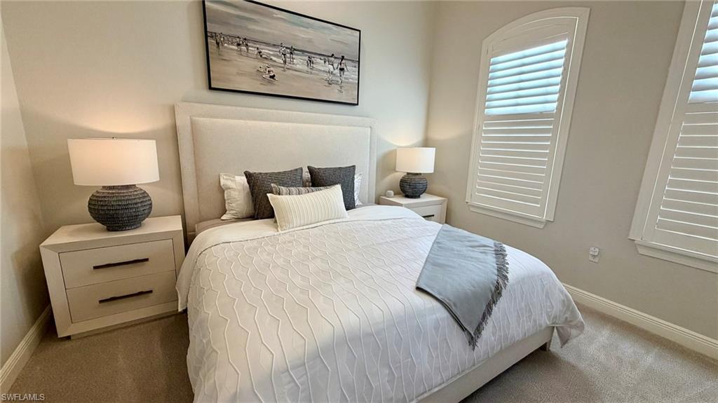 15536 Monterosso Lane, Unit 201 Naples, FL 34110 - Photo 16 of 29 a bedroom with bed and a window