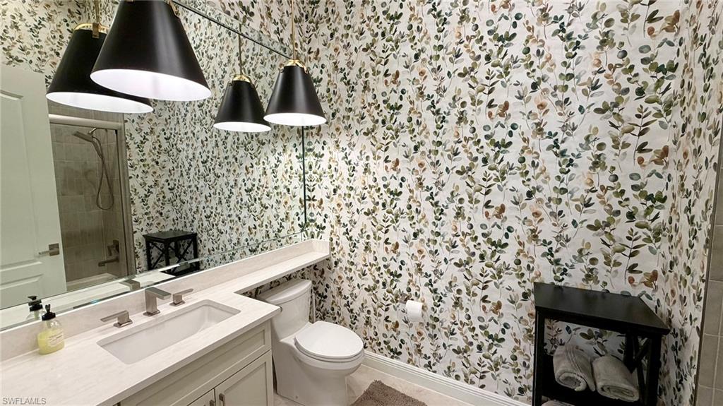 15536 Monterosso Lane, Unit 201 Naples, FL 34110 - Photo 18 of 29 a bathroom with a toilet and a sink