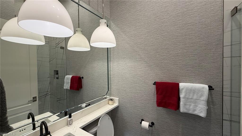 15536 Monterosso Lane, Unit 201 Naples, FL 34110 - Photo 19 of 29 a bathroom with a shower