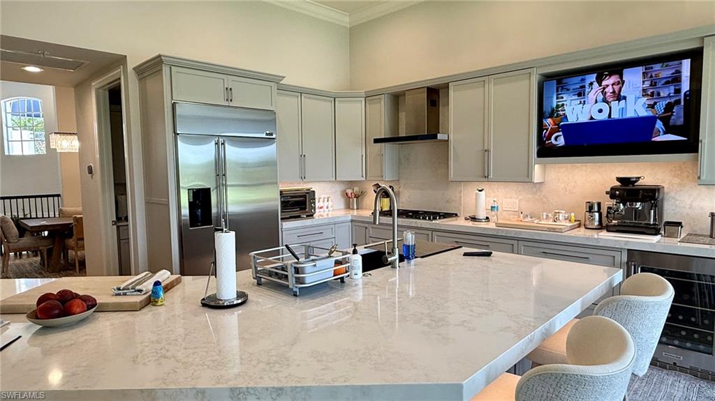 15536 Monterosso Lane, Unit 201 Naples, FL 34110 - Photo 5 of 29 a kitchen with a table and chairs