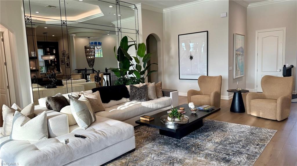 15536 Monterosso Lane, Unit 201 Naples, FL 34110 - Photo 7 of 29 a living room with furniture and wooden floor