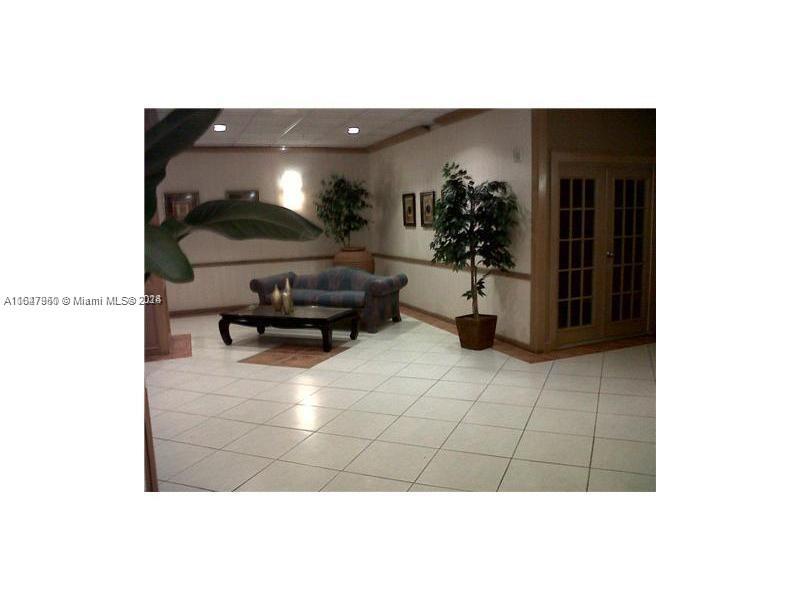 2750 Northeast 183rd Street, Unit 707 Aventura, FL 33160 - Photo 2 of 8 a living room with furniture and a potted plant