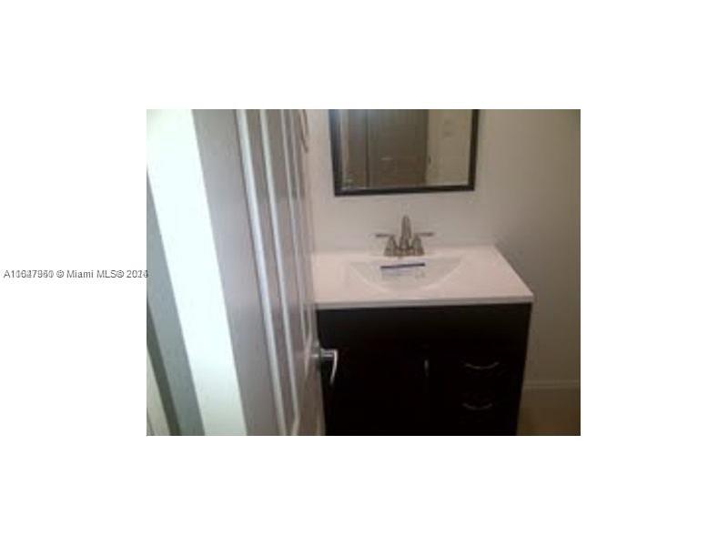 2750 Northeast 183rd Street, Unit 707 Aventura, FL 33160 - Photo 4 of 8 a bathroom with a sink and mirror