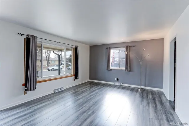 wooden floor in an empty room with a window
