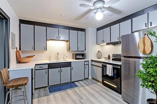 a kitchen with stainless steel appliances granite countertop a stove refrigerator sink and cabinets