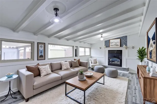 a living room with furniture a fireplace and a chandelier