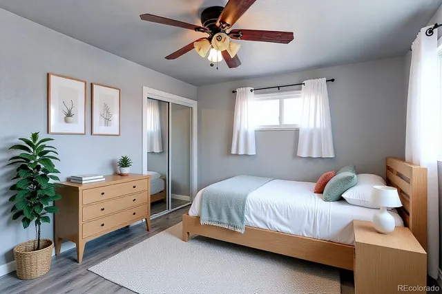 a bedroom with a bed and a potted plant