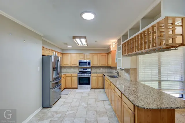 a kitchen with a stove a sink and a refrigerator