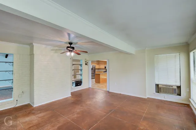 a view of a kitchen with a sink and a chandelier fan
