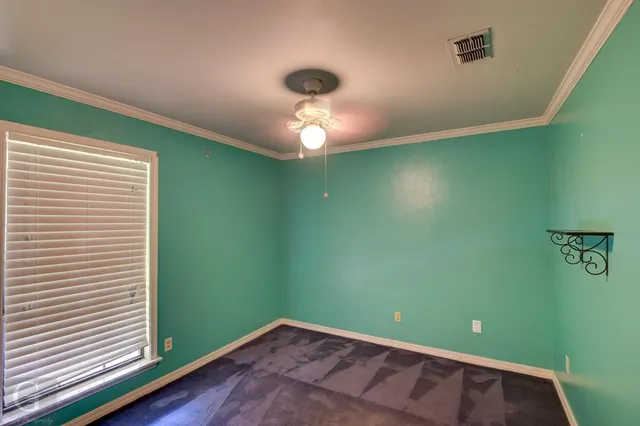 a view of a room with a fan and a window