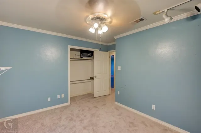 a view of a chandelier fan and entryway