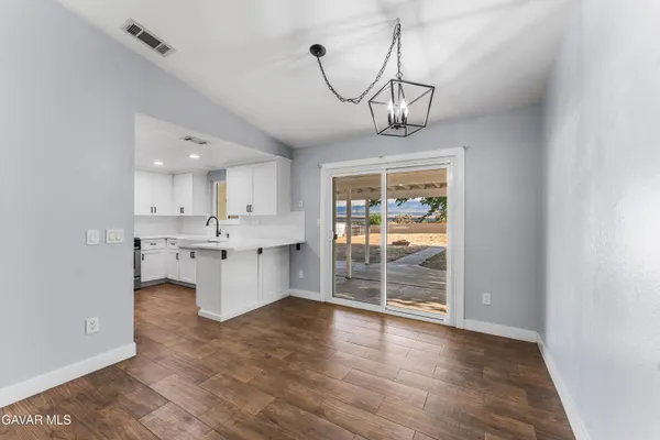 a view of a kitchen with a sink and cabinet