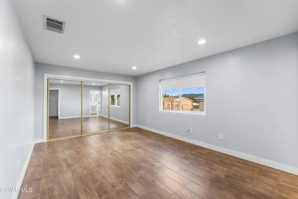 a view of room with wooden floor and window
