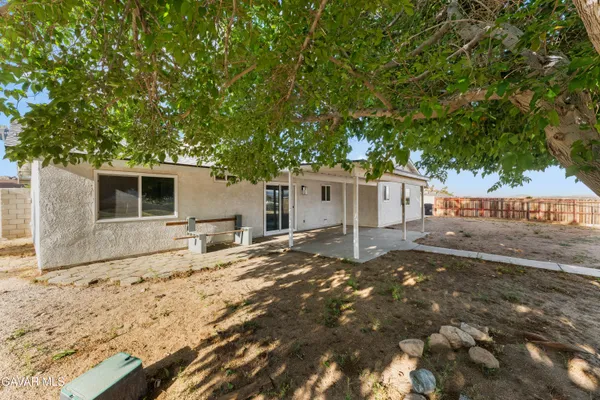 a backyard of a house with large tree