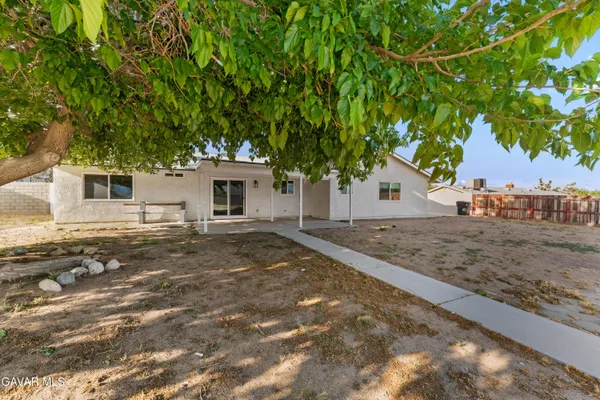 a view of a house with a tree