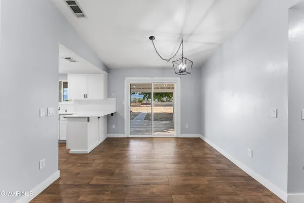 a very nice looking room with a large window and wooden floor