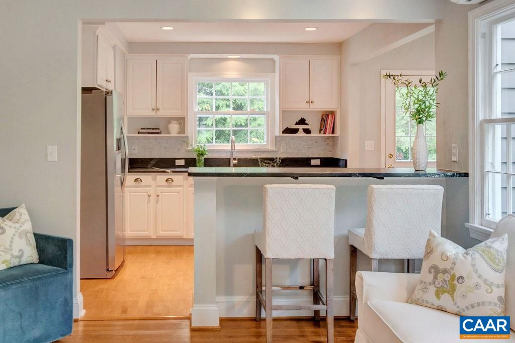 1415 Dairy Road Charlottesville, VA 22903 - Photo 9 of 49 a kitchen with stainless steel appliances granite countertop a table chairs sink and cabinets