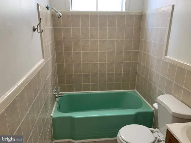 a bathroom with a sink toilet and bathtub