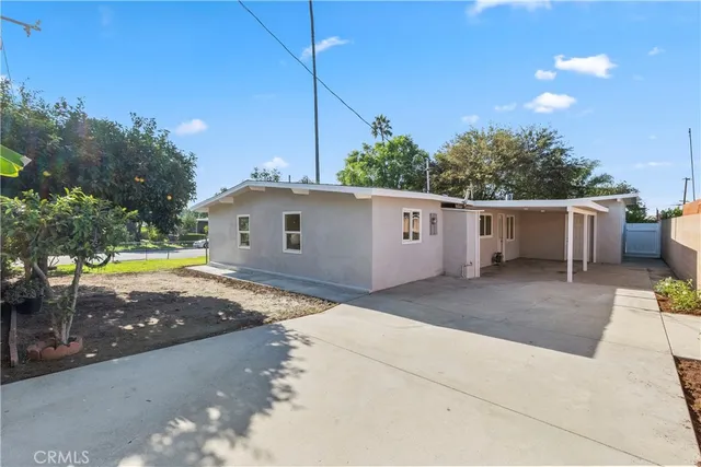 a view of house with backyard space and tree