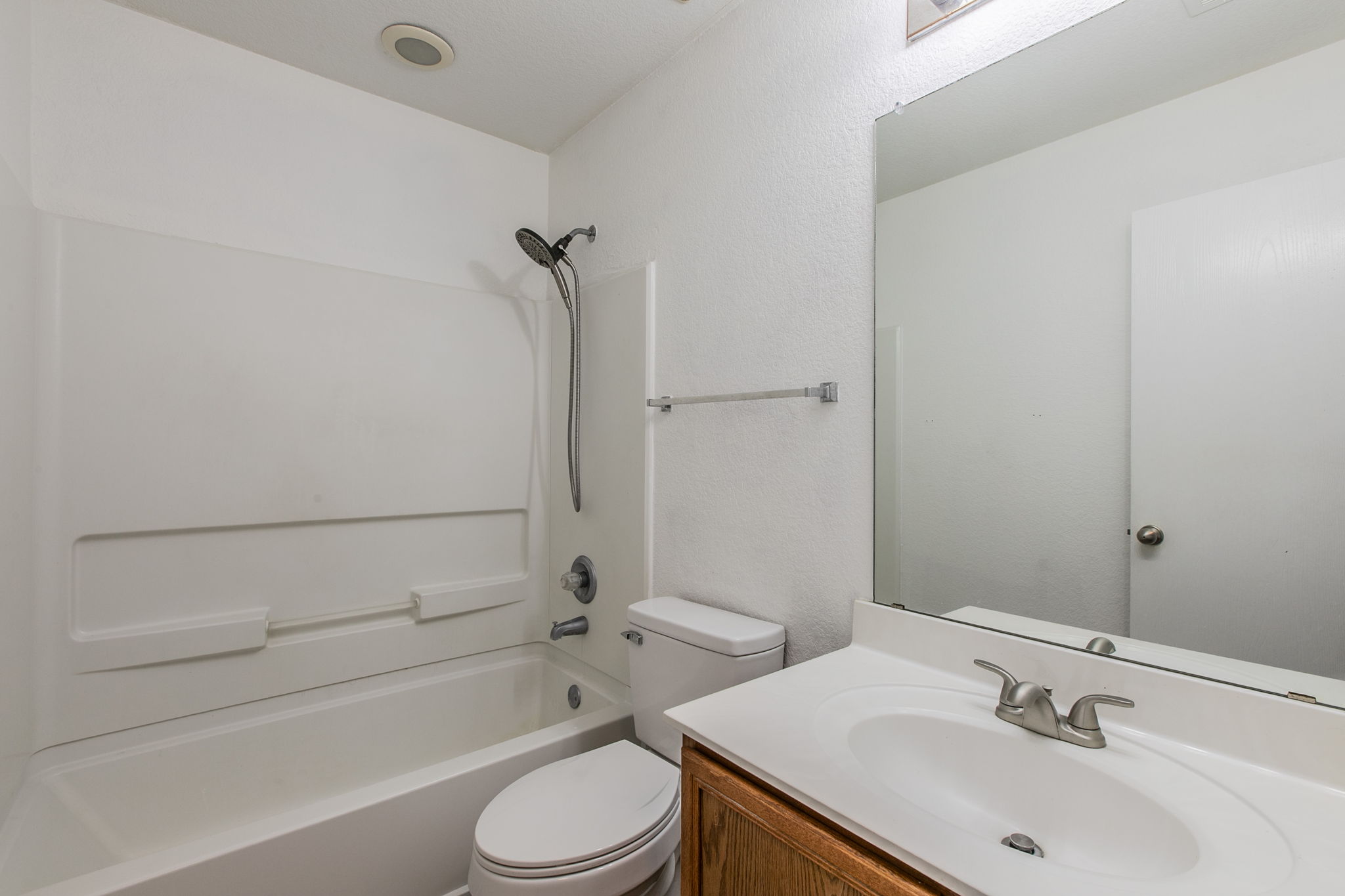 157 Lex Word Kyle, TX 78640 - Photo 21 of 34 Clean lines and classic fixtures define this functional bathroom with a wood vanity.