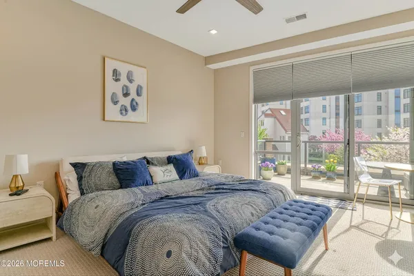 a bedroom with a bed and glass window