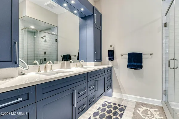 a bathroom with a double vanity sink and a mirror