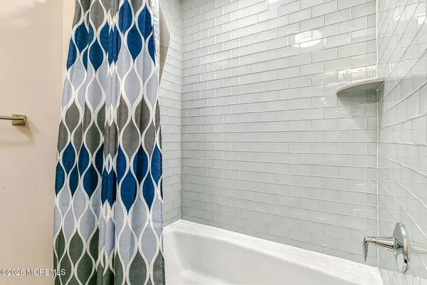 a bathroom with a bathtub and shower