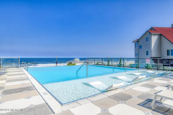 a view of swimming pool with outdoor seating