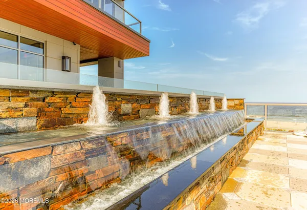 a view of a swimming pool and outdoor seating