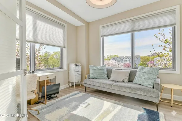 a living room with fireplace furniture and a large window