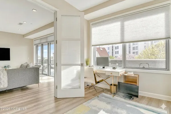 a room with furniture large window and wooden floor