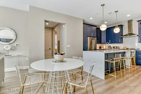 a kitchen with kitchen island a dining table and chairs