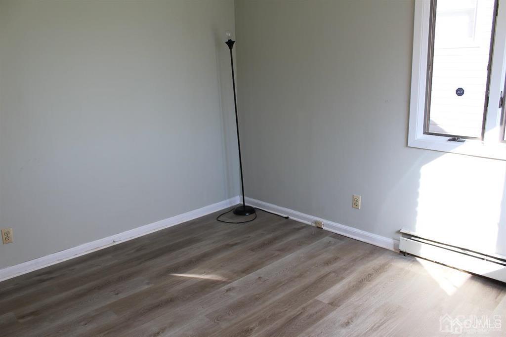 8 Maple Road Iselin, NJ 08830 - Photo 11 of 21 a view of an empty room with wooden floor