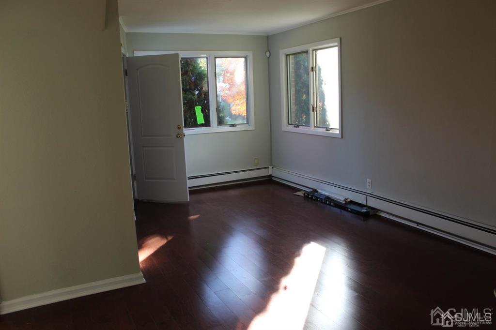 8 Maple Road Iselin, NJ 08830 - Photo 12 of 21 an empty room with wooden floor and windows