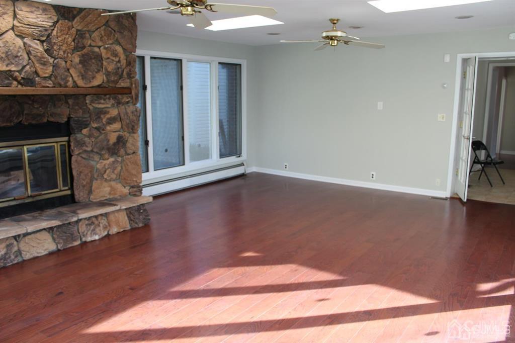 8 Maple Road Iselin, NJ 08830 - Photo 14 of 21 a view of a livingroom with wooden floor and a fireplace