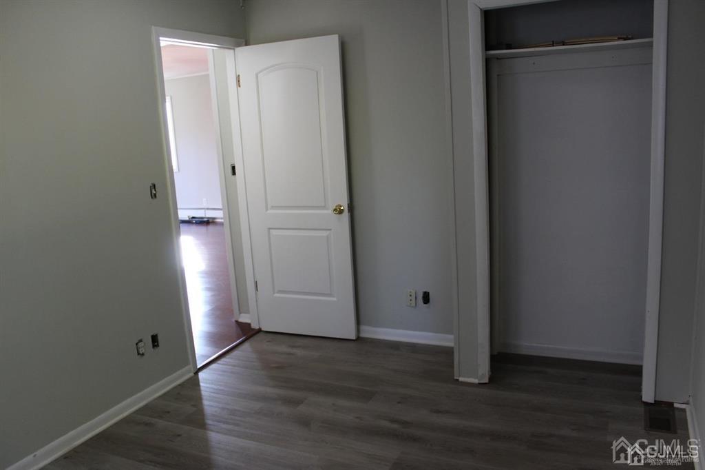 8 Maple Road Iselin, NJ 08830 - Photo 16 of 21 a view of an empty room with wooden floor