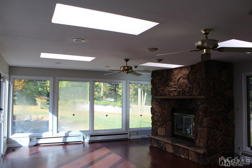 8 Maple Road Iselin, NJ 08830 - Photo 18 of 21 a living room with furniture and a fireplace