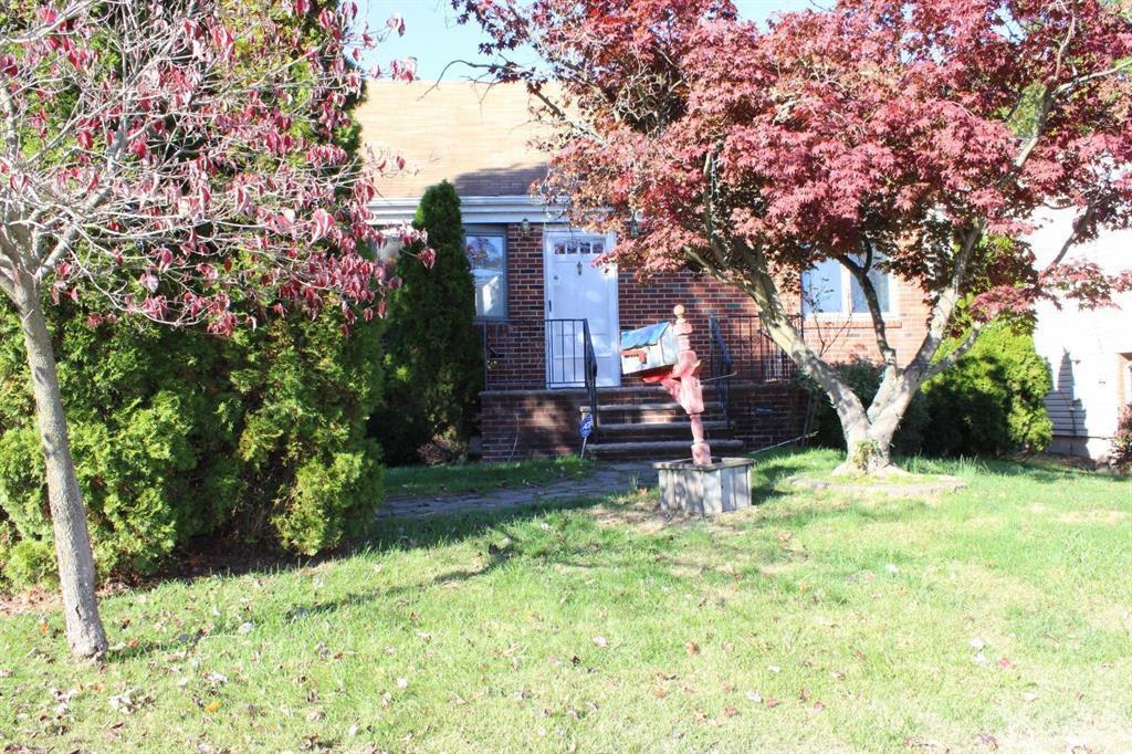 8 Maple Road Iselin, NJ 08830 - Photo 19 of 21 a backyard of a house with lots of green space and fountain