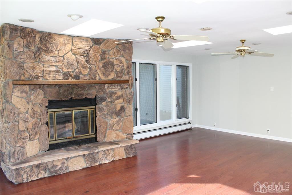 8 Maple Road Iselin, NJ 08830 - Photo 2 of 21 a view of a livingroom with a fireplace and wooden floor