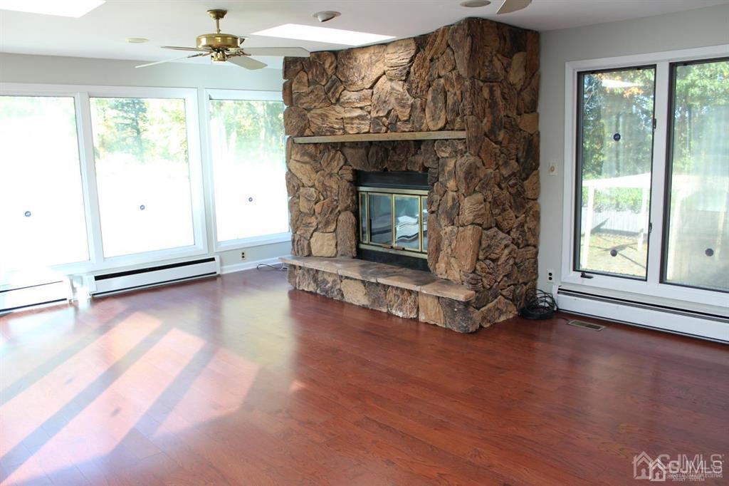 8 Maple Road Iselin, NJ 08830 - Photo 3 of 21 a living room with a fireplace with wooden floor