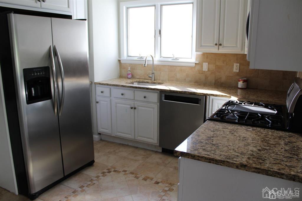 8 Maple Road Iselin, NJ 08830 - Photo 4 of 21 a kitchen with granite countertop a refrigerator and a sink