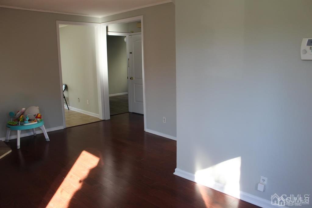 8 Maple Road Iselin, NJ 08830 - Photo 5 of 21 a view of a hallway with wooden floor