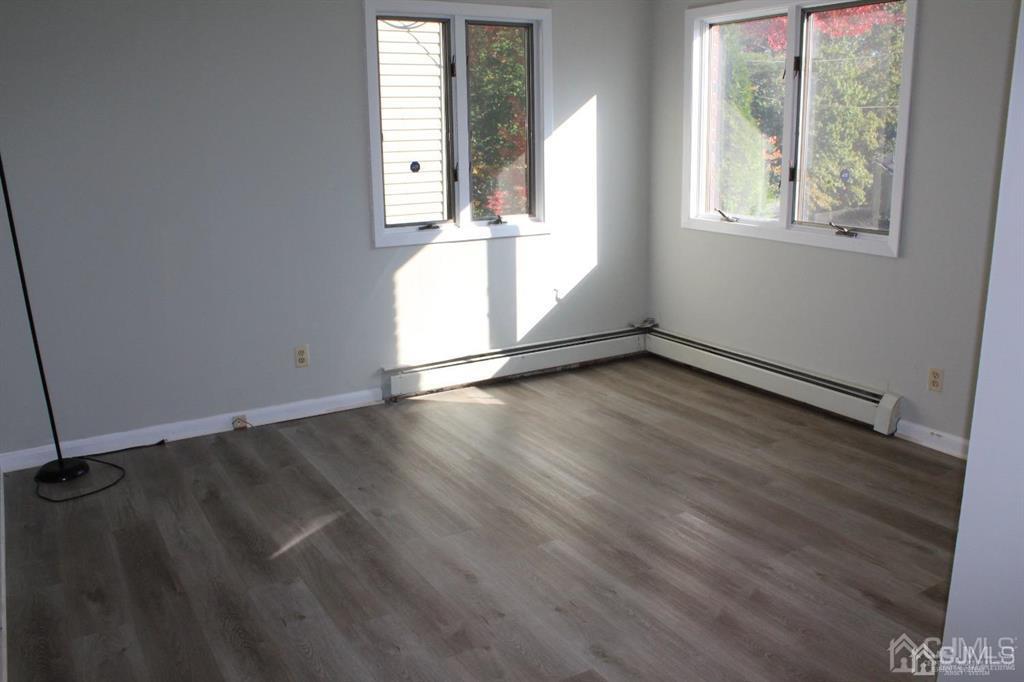 8 Maple Road Iselin, NJ 08830 - Photo 8 of 21 an empty room with wooden floor and windows
