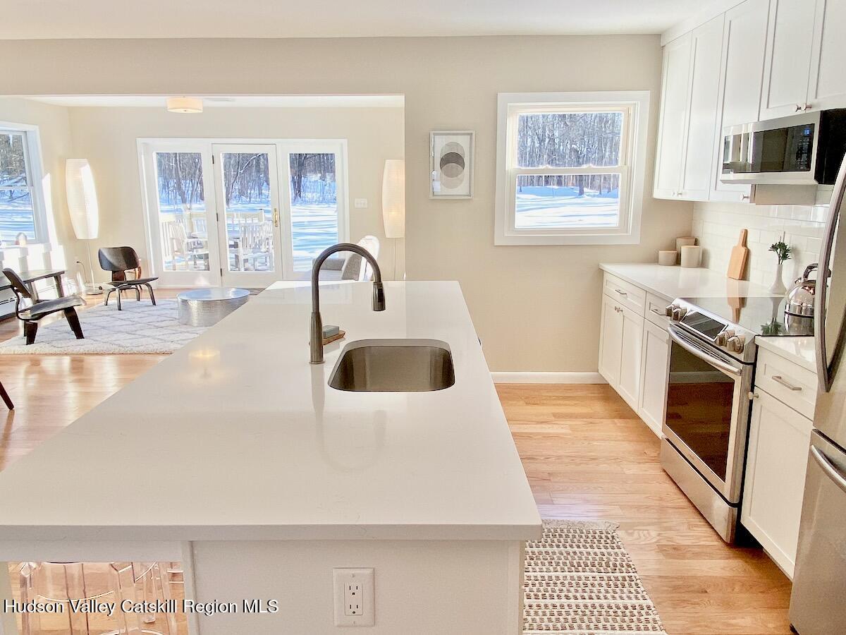 132 Weeds Mill Road Highland, NY 12528 - Photo 13 of 37 a kitchen with a stove a sink and a microwave
