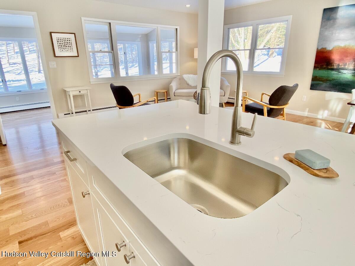 132 Weeds Mill Road Highland, NY 12528 - Photo 16 of 37 a kitchen with a sink and a stove with wooden floor