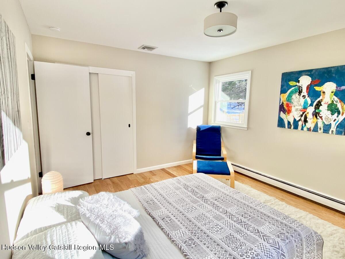 132 Weeds Mill Road Highland, NY 12528 - Photo 24 of 37 a bedroom with a bed and a painting on the wall